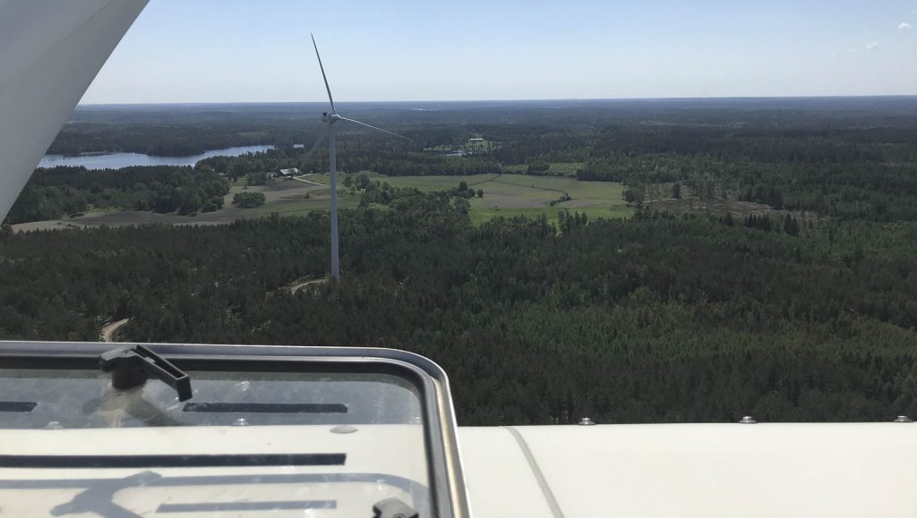 A wind turbine in the middle of the forest