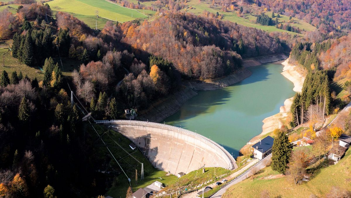 an aerial photograph of a dam and a lake